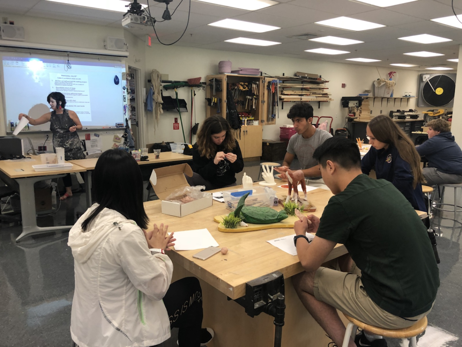 Students working together during a hands-on creative workshop in the summer program