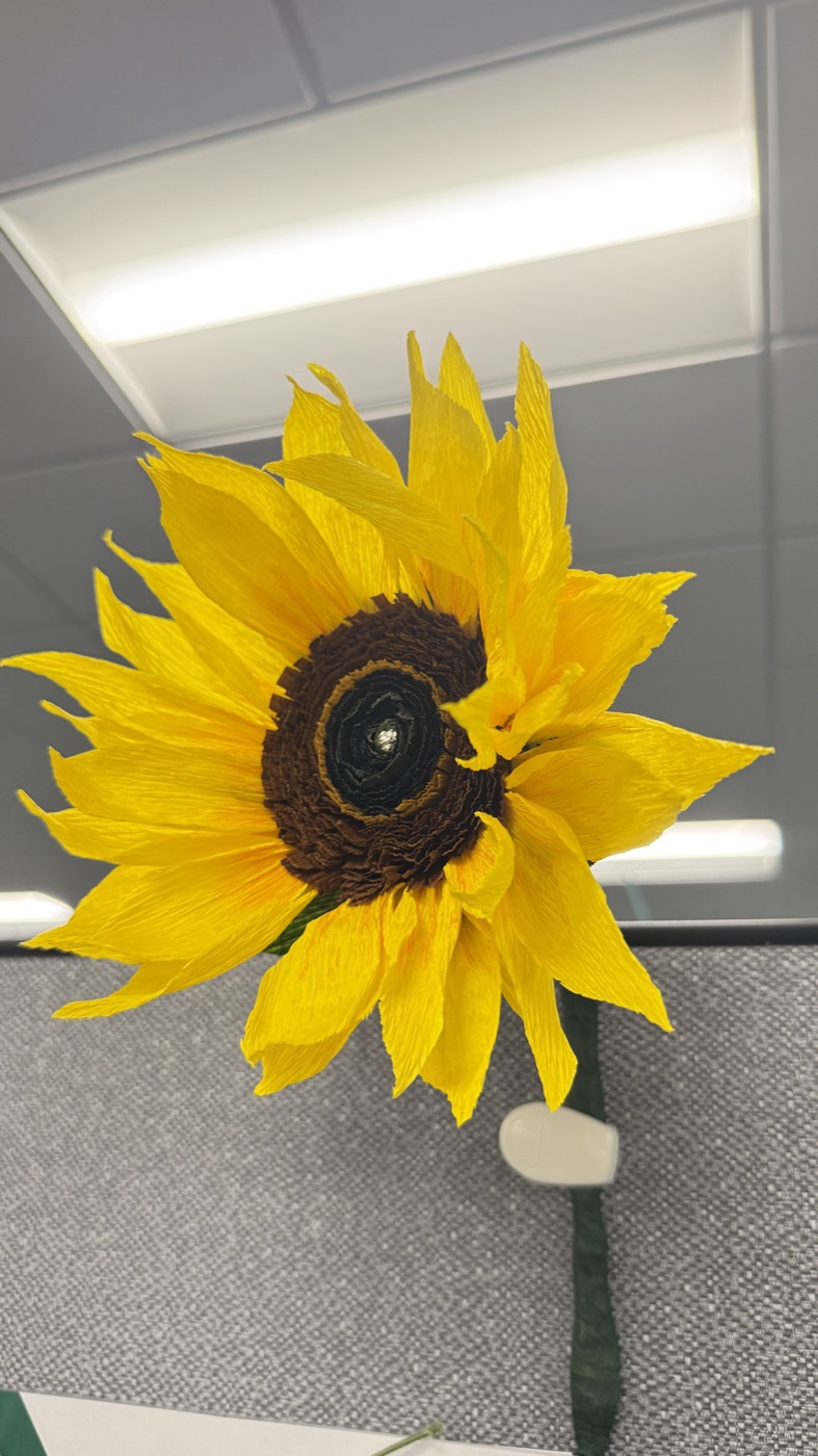 A sunflower handmade from yellow crepe paper